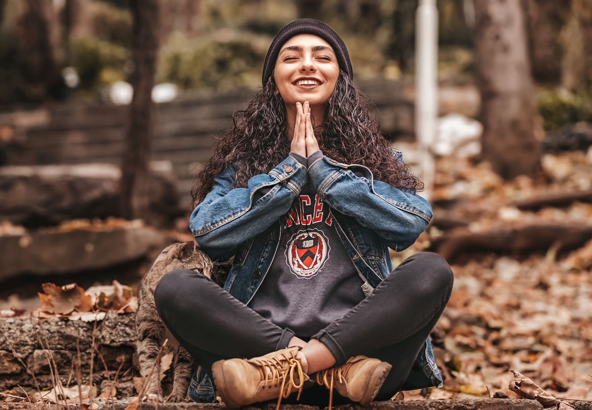 A young lady meditating with a smile on her face