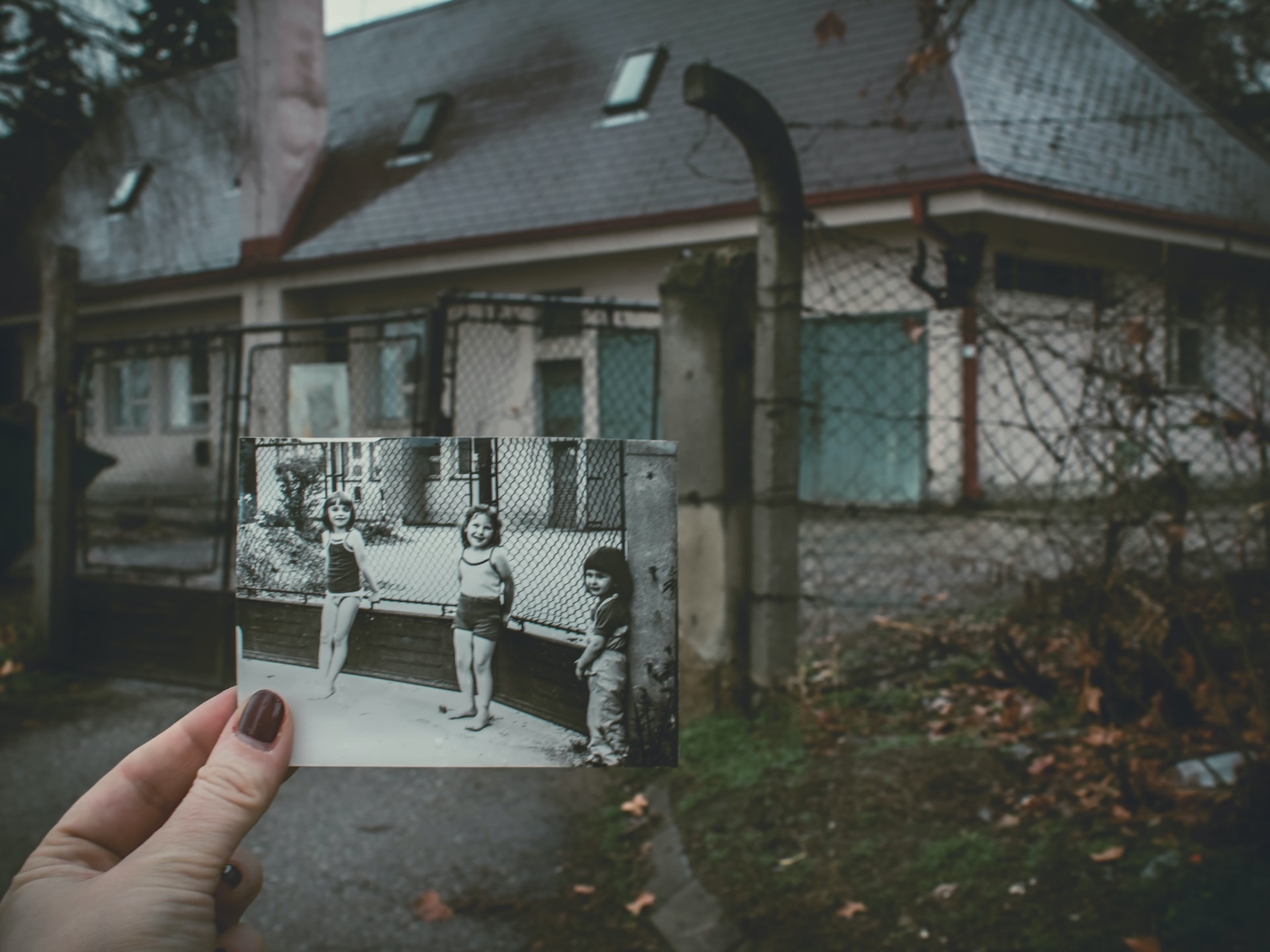 Looking at childhood photo in front of same old house