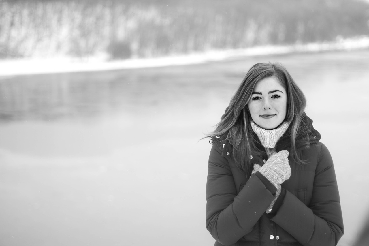 A young lady standing in the middle of the winter